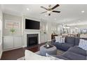 Cozy living room with a fireplace, built-in cabinets, and a comfortable sectional sofa at 3724 Via Secco Ln, Suwanee, GA 30024