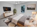 This staged bedroom features neutral walls, updated ceiling fan, and an abundance of natural light at 5520 Morning Creek Cir, Atlanta, GA 30349