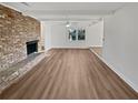 Bright, airy living room with hardwood floors, a beautiful fireplace, ceiling fan, and freshly painted white walls at 5520 Morning Creek Cir, Atlanta, GA 30349