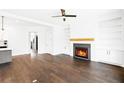 Inviting living room featuring hardwood floors, a cozy fireplace, and custom built-in shelving at 837 Lakemont Dr, Canton, GA 30114