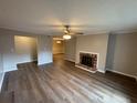 Open living room featuring a brick fireplace and hardwood flooring at 2992 Parc Lorraine, Lithonia, GA 30038