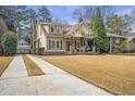Beautiful craftsman style home featuring an inviting front porch, long driveway and detached garage at 3207 Kensington Rd, Avondale Estates, GA 30002