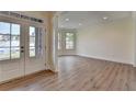 Inviting foyer with wood floors and lots of natural light and views to the neighborhood at 5533 Addison Woods Pl, Buford, GA 30518