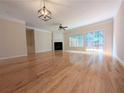 Spacious and bright living room with beautiful hardwood floors and fireplace at 11780 Wellsley Way, Alpharetta, GA 30005