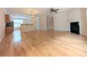 Open-concept living space featuring hardwood floors, fireplace, and neutral paint at 11780 Wellsley Way, Alpharetta, GA 30005