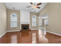 Spacious living room featuring a fireplace, hardwood floors, and plenty of natural light at 1850 Westwind Dr, Cumming, GA 30041