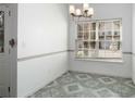Bright dining area featuring tile floor, ample natural light, and modern chandelier at 6439 Grey Fox Way, Riverdale, GA 30296