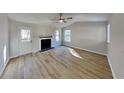 Bright living room offers modern ceiling fan and fireplace at 7021 Hillcrest Chase Ln, Austell, GA 30168