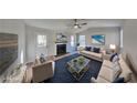 Bright living room offers modern ceiling fan, fireplace, and is virtually staged at 7021 Hillcrest Chase Ln, Austell, GA 30168