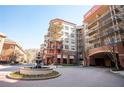 Attractive condos with balconies and a fountain in the foreground at 200 River Vista Dr # 736, Atlanta, GA 30339