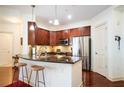 Modern kitchen boasts stainless steel appliances, granite countertops and an island with barstool seating at 200 River Vista Dr # 736, Atlanta, GA 30339