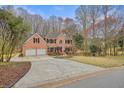 Beautiful brick house featuring an extra-long driveway and manicured lawn at 465 Woodbrook Way, Lawrenceville, GA 30043