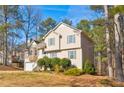 Side view of a two-story home with neutral siding, manicured bushes, and a lush lawn at 47 Greatwood Dr, White, GA 30184