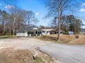 Side view of renovated house with a light colored exterior and visible 'for sale' sign at 1190 Dallas Hwy, Villa Rica, GA 30180