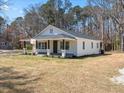 Newly renovated home with white exterior and a cozy front porch, surrounded by a green lawn at 1190 Dallas Hwy, Villa Rica, GA 30180