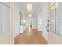Bright foyer with hardwood floors, modern light fixtures, and elegant decor creating a welcoming entrance at 2849 Parkridge Ne Dr, Brookhaven, GA 30319