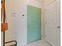 Entry way featuring a light green front door, adjacent to a white closet door and security system at 400 17Th Nw St # 2025, Atlanta, GA 30363