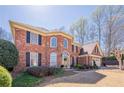 Beautiful brick home with black shutters, an arched entryway, well-manicured lawn and a two-car garage at 6820 Olde Atlanta Pkwy, Suwanee, GA 30024