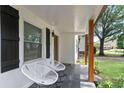Charming front porch with seating, dark shutters and a view of the landscaped front yard at 1377 Marston St, Smyrna, GA 30080