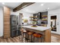 Kitchen with modern appliances, floating shelves, and wooden accents throughout at 1377 Marston St, Smyrna, GA 30080