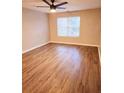 Spacious bedroom featuring wood-look floors, a ceiling fan and a bright window with blinds at 2302 Waldrop Pl, Decatur, GA 30034