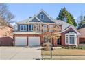 Attractive brick home with a manicured lawn, lovely landscaping and an attached garage at 3311 Fieldwood Se Dr, Smyrna, GA 30080