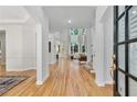 Inviting foyer with hardwood floors, leading into the living room with large windows at 3311 Fieldwood Se Dr, Smyrna, GA 30080