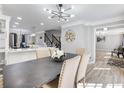 Open dining area flows into a modern kitchen, featuring hardwood floors and stylish decor at 4833 Glenwhite Dr, Duluth, GA 30096