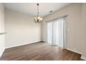Cozy dining area with laminate flooring, modern lighting, and sliding glass door at 5538 Cascade Sw Rdg, Atlanta, GA 30336