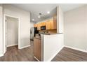 Efficient kitchen with wood cabinets, stainless steel appliances, and laminate flooring at 5538 Cascade Sw Rdg, Atlanta, GA 30336