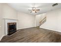 Spacious living room featuring wood floors, a fireplace, ceiling fan, and staircase at 5538 Cascade Sw Rdg, Atlanta, GA 30336