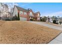 Charming two-story brick home with a well-manicured lawn and attached two-car garage at 675 Timber Ives Dr, Dacula, GA 30019