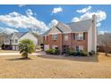 Two-story brick home with manicured lawn, attached two-car garage, separate building and inviting front entrance at 120 Sunflower Ln, Covington, GA 30016