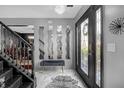 Elegant foyer with decorative mirrors, zebra rug, and staircase with ornate wrought iron railing at 120 Sunflower Ln, Covington, GA 30016