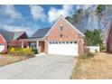 Charming brick home with a two-car garage, inviting front yard, and a well-maintained lawn at 499 Bellbrook Ln, Lawrenceville, GA 30045