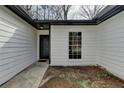 Close up of a charming one story home with white siding and black trim at 5393 Ridge Forest Dr, Stone Mountain, GA 30083