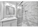 Beautiful bathroom with a marble vanity, stylish lighting, and a sleek glass-enclosed shower with decorative tiling at 609 Old Wheat Ne St, Atlanta, GA 30312