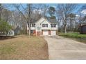 Charming two-story home with white siding, brick accents, attached garage, and well-maintained lawn at 1542 Bogota Way, Jonesboro, GA 30236