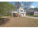 Traditional home with a two-car garage, stairs leading to the front door, and front yard at 1542 Bogota Way, Jonesboro, GA 30236