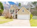 Traditional two-story home with a two-car garage, complemented by green lawn and mature trees at 3045 Arden Ridge Dr, Suwanee, GA 30024