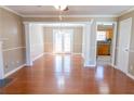 Bright living area featuring hardwood floors, white columns, and French doors leading to the backyard at 3045 Arden Ridge Dr, Suwanee, GA 30024