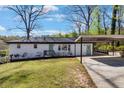 Charming single-story home with white brick, a green door, carport, and well-maintained lawn at 629 Moselle Sw Dr, Mableton, GA 30126