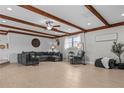 Spacious living room with wood beam ceiling, light floors, and ample seating at 4739 Lower Jersey Rd, Oxford, GA 30054