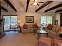 Inviting living room with beamed ceilings and screened in porch access on either side at 2894 Dellinger Dr, Marietta, GA 30062