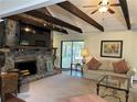 Cozy living room featuring a stone fireplace, plush seating, and natural light at 2894 Dellinger Dr, Marietta, GA 30062