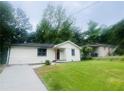 Well-maintained one-story home with a tidy lawn and a concrete driveway at 53 Springside Se Dr, Atlanta, GA 30354