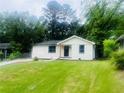 Inviting one-story home with a freshly painted exterior, a tidy lawn, and neatly landscaped flower beds at 53 Springside Se Dr, Atlanta, GA 30354