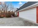 Attached multi-car garage, white doors, with a brick exterior and a view of the wooden deck at 816 Ivy Ridge Dr, Loganville, GA 30052