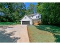 Charming two-story home with attached garage, driveway, and well-maintained lawn at 2143 Lyle Ave, College Park, GA 30337