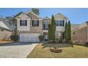 Charming two-story home with manicured lawn, brick accents, and two car garage at 379 Peachstone Way, Lawrenceville, GA 30043